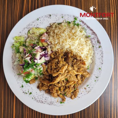 Plate with cooked rice, seasoned grilled meat, and a mixed salad on a wooden table, with Montfort Mediterranean Grill logo.