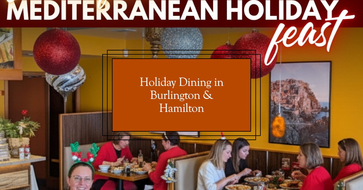 People enjoying a festive holiday meal together in a warmly decorated Mediterranean restaurant with red and blue hanging ornaments.